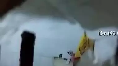 There is a hole in the bathroom and perv films the naked Indian