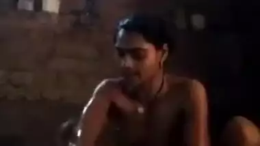 Young Desi woman sets the camera against her and starts washing XXX body